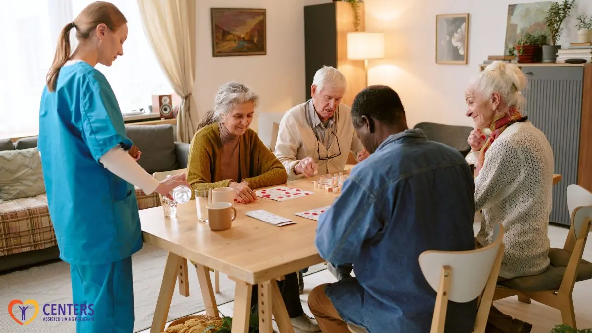 assisted-living-residents-playing-card-game-with-caregiver-support