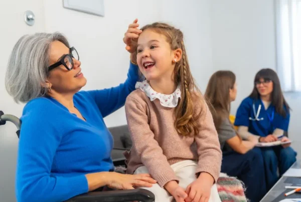 caregiver-and-child-in-clinic-waiting-room-smiling-together
