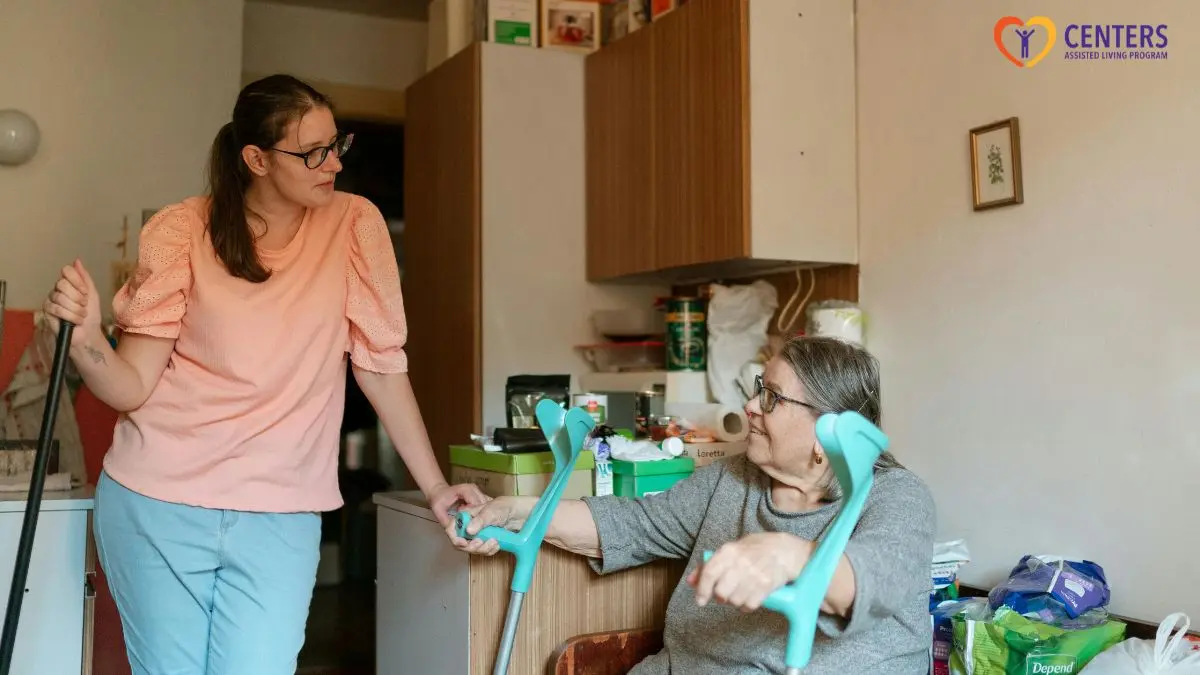 caregiver-talking-with-senior-woman-at-home-with-crutches-support