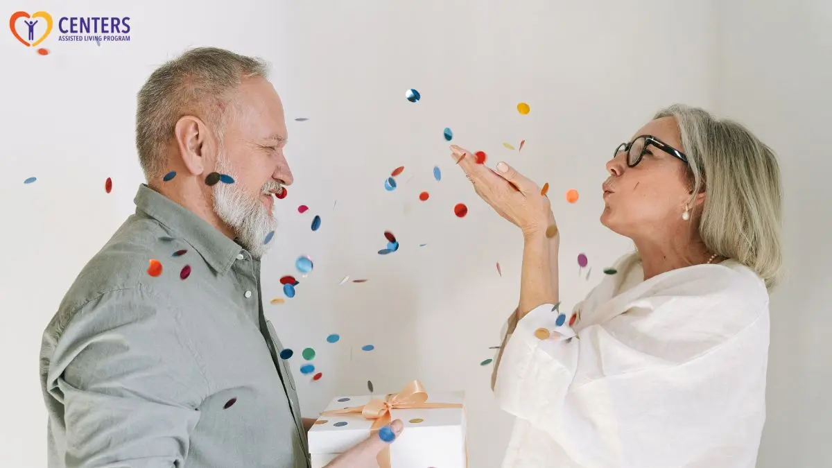older-couple-celebrating-with-confetti-and-gift-box
