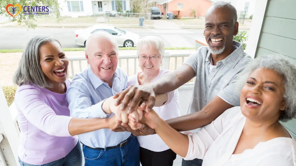 senior-community-friends-stacking-hands-smiling-together